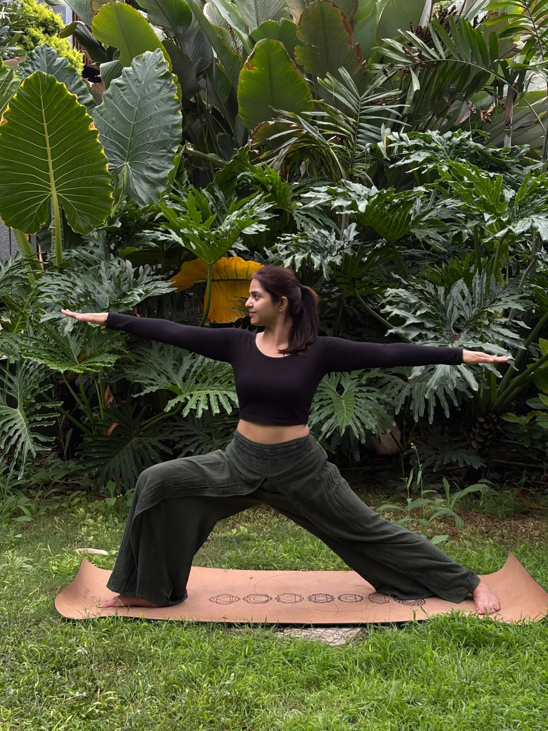 Yoga practitioner holding Warrior II outdoors